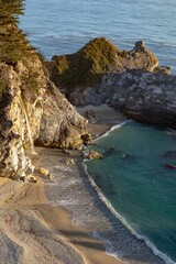McWay Falls tumbles onto the beach at Julia Pfeiffer Burns State Park. The waterfall flows...