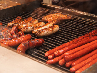 Grilled Sausages and Hot Dogs on a Barbecue