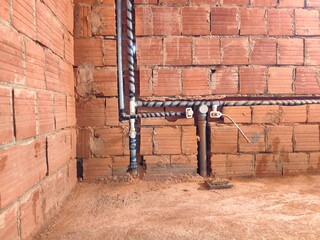 Plumbing installation work. Plastic pipes with thermal insulation in modern design bathroom....