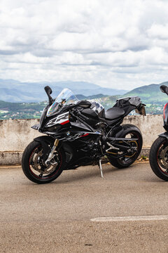 Black BMW S1000RR parked at a scenic mountain viewpoint