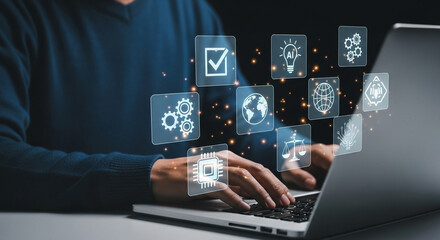 Person typing on laptop with glowing icons representing technology and business concepts displayed above