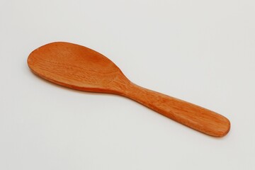 Eco-friendly wooden rice spoon on white background