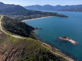 Mountain with dirt road in the middle of nature with views to two incredible beaches with turquoise water