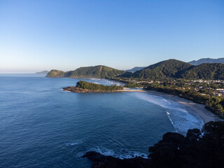 Fototapeta premium Small island between two beaches with green waters Camburi