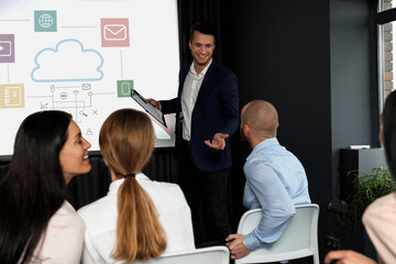 Business trainer giving lecture using video projector in conference room. Scheme with illustrations...