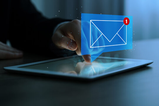 Email marketing, new message notification. Man using tablet computer at table indoors, closeup