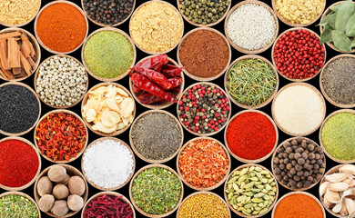 Set of different aromatic spices in bowls on black background, flat lay. Banner design