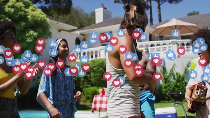 Man stepping to center dancing poolside while friends clapping as social media icons flooding
