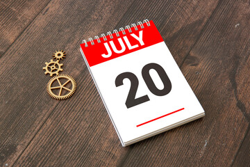 Wooden calendar July 20 on a white background close up
