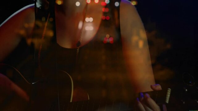 Teen musician playing guitar and singing in concert with drifting headlights overlay guiding shot