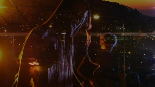 Female musician pressing synth knob singing while male guitarist strumming on rooftop driving music