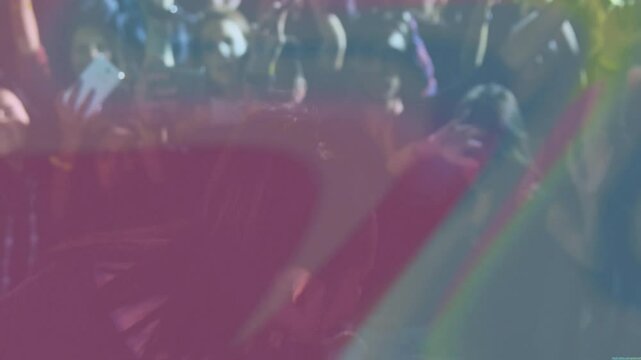 Singer grabbing mic singing onstage, engaging music crowd with rainbow lights sweeping across stage