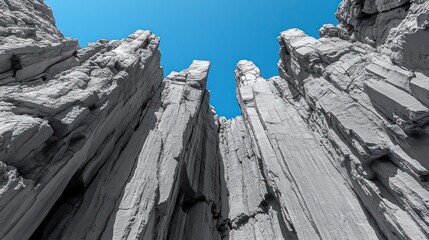 Gray rock formations rise towards a vibrant sky