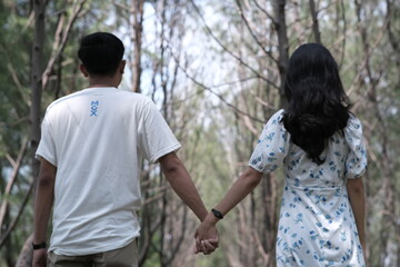 young couple walking in the woods