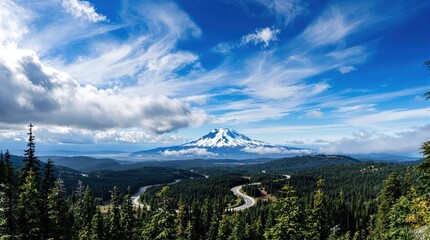 Panoramic view of a majestic mountain peak, framed by a winding road and lush forests, under a vibrant blue sky dotted with fluffy clouds