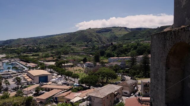 Panoramic view of Tropea port, buildings, and surrounding hills, seen from the ruins of the Norman Castle, in Calabria, Italy