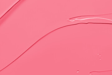Pink lipstick, cream blush background. Creamy makeup product or paint texture