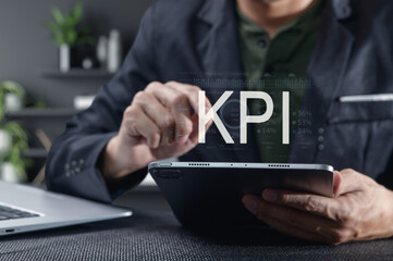 Businessman Analyzing Key Performance Indicators on Tablet Device