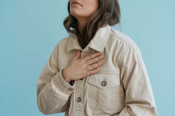 lady holding hand on chest in jacket