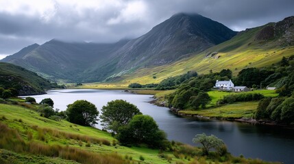 Farmhouse by mountain lake in rural valley

