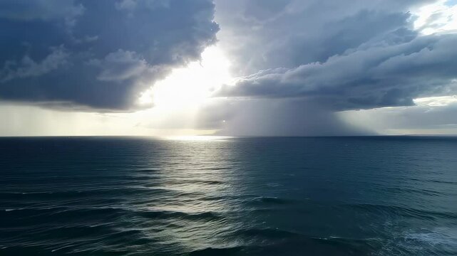 Dramatic Ocean View, Rainstorm Over the Sea with Sun Rays Breaking Through the Clouds
