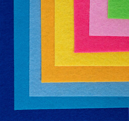 Layered square felt sheets in vibrant rainbow color arrangement