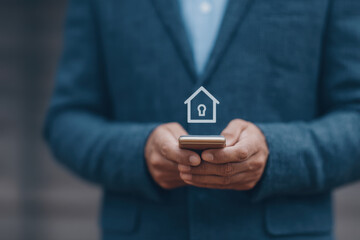 Businessman holding smartphone with digital house lock icon, representing secure online home insurance and modern technology solutions