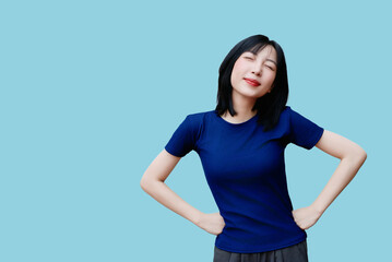 Enjoying a moment of relaxation with a smile against a blue background, showcasing joy and comfort...