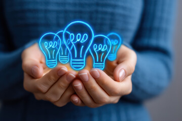 Hands holding glowing blue light bulb icons, symbolizing innovation, creativity, digital entrepreneurship, and startup ideas