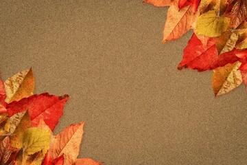 Naklejka premium Clusters of autumn leaves are spreading across flat design textured brown paper surface corners