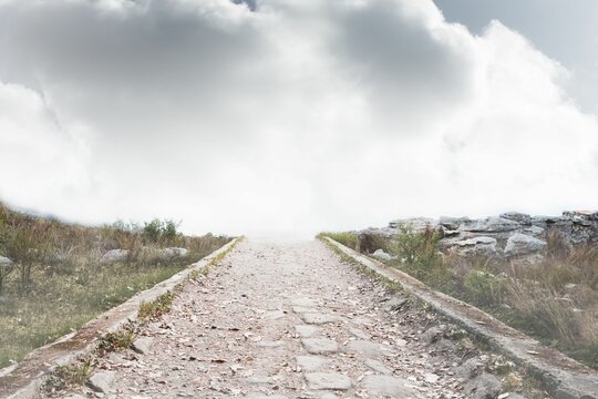 Fototapeta Stony path leading to misty horizon