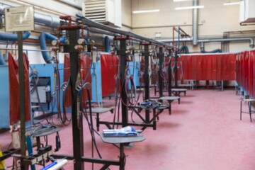 Flat design welding booths are filling workshop area with red curtains, torches, hoses, ducts