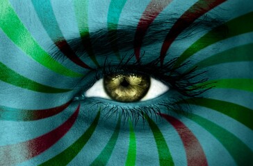 Green eye on patterned face