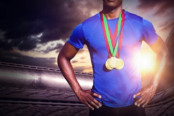 Midsection of male athlete standing at stadium