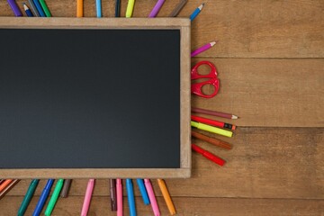 High angle view of chalkboard with multi colored equipment