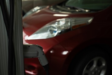 Charging plug hanging at charging station