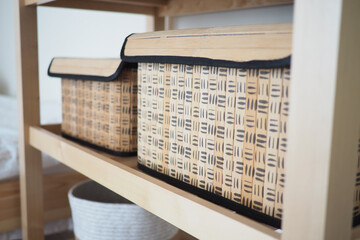 Storage baskets on a wooden shelf in a modern space