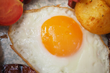 Delicious breakfast with fried egg and potatoes served hot