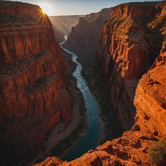 Describe the dramatic beauty of a canyon carved over centuries, glowing orange and red under a sinking sun