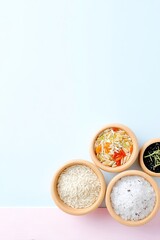 Top View Organic Grains in Kraft Bowls on Pastel Background