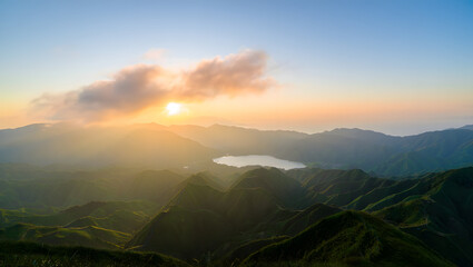 Golden Sunrise Over Lush Green Mountains and Lake sunset