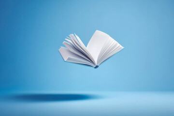Open Book Hovering in Minimalist Blue Studio Scene