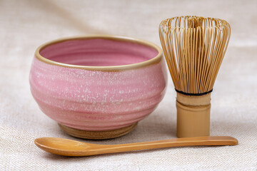 Pink Glazed Tea Bowl With Chasen and Spoon on Table