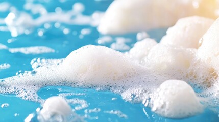 Obraz premium Close-up of bubbly blue water. Soft, white foam on surface