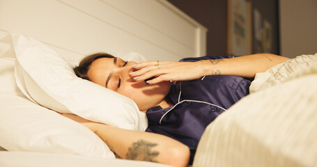 Comfortable, sleeping and yawn with woman in bed for morning or weekend break and wellness....
