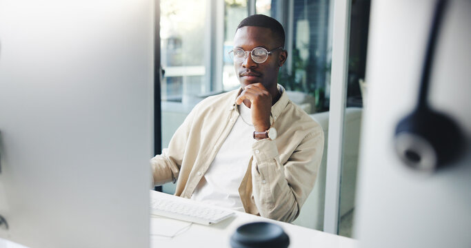 Thinking, computer and black man in office with ideas, research or brainstorming for creative project. Planning, technology and African male editor working on article for publishing at agency.