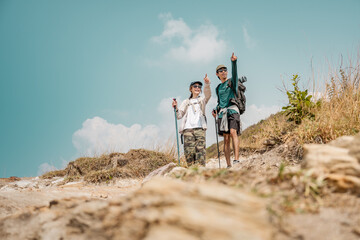 Asian couple hiking mountain trail. Hiker lifestyles activity. Hike trekking backpacker. Backpacker trekking outdoors.