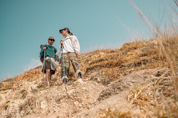 Asian couple hiking mountain trail. Hiker lifestyles activity. Hike trekking backpacker. Backpacker trekking outdoors.