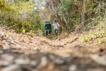 Asian couple hiking forest trail. Hiker lifestyles activity. Hike trekking backpacker. Backpacker trekking outdoors.