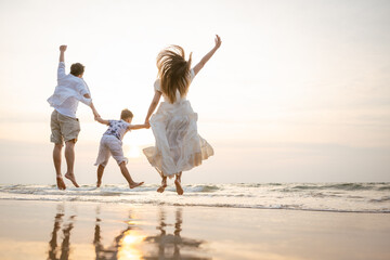 Family holiday vacation beach. Asian happy family outdoors summer travel. Fun families outdoors. Family vacation beach.